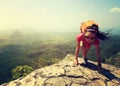 woman hiker climbing rock on mountain peak cliff Royalty Free Stock Photo