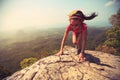 woman hiker climbing rock on mountain peak cliff Royalty Free Stock Photo