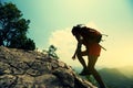 Woman hiker climbing rock on mountain peak cliff Royalty Free Stock Photo