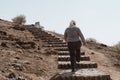 Woman hiker climbs the steep staircase to Observation Hill in Amboseli National Park Kenya Africa Royalty Free Stock Photo