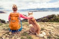 Woman hiker with dog looking at sea Royalty Free Stock Photo