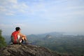 Woman hiker enjoy the view at mountain peak cliff Royalty Free Stock Photo