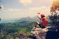 Woman hiker enjoy the view on mountain top cliff Royalty Free Stock Photo