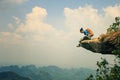 Woman hiker enjoy the view on mountain top rock Royalty Free Stock Photo