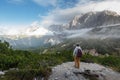 Woman hiker enjoy the view stand at cliff edge on mountain Royalty Free Stock Photo