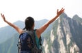 Woman hiker excited mountain peak