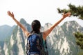 Woman hiker excited mountain peak