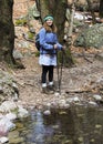 A Woman Hiker by a Forest Creek