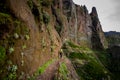 Woman hiker is going on the edge of steep mountain Royalty Free Stock Photo