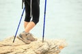 Woman hiker hiking stand on seaside rock Royalty Free Stock Photo