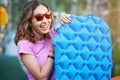 Woman hiker with inflatable mat for comfortable and warm sleep in a tent camping outdoors. Reliable reflection of cold and Royalty Free Stock Photo