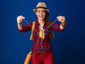 Woman hiker isolated on blue background giving headphones