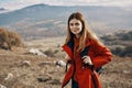 woman hiker in a jacket and with a backpack are resting in the mountains landscape Relax model