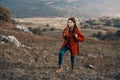 woman hiker in jacket boots with backpack travel in mountains landscape