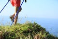 Woman hiker legs hiking on seaside mountain