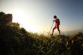 Woman hiker legs hiking on seaside mountain