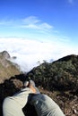 Woman hiker legs sit on beautiful mountain peak Royalty Free Stock Photo