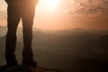 Woman hiker legs in tourist boots stand on mountain rocky peak. Sunny day Royalty Free Stock Photo