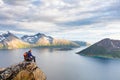 Woman hiker looking at a beautiful Norwegian Fjord landscape Royalty Free Stock Photo