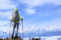 Woman hiker looking at the beautiful snow mountain summits