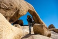 Woman Hiker Looking Up At Arch Rock Royalty Free Stock Photo