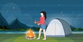 Woman hiker making fire girl holding firewood for bonfire hiking camping concept traveler on hike beautiful night
