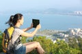 Woman hiker use digital tablet mountain peak