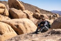 Woman Hiker Patiently Sits On Rock Royalty Free Stock Photo