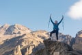 Woman hiker portrait. She is standing on a mountain peak, looking at nature landscape