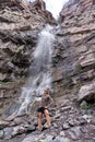 Woman hiker poses at Cascade Falls waterfall in Ouray Colorado Royalty Free Stock Photo