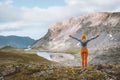 Woman hiker raised hands enjoying mountain lake view travel hiking outdoor active healthy lifestyle Royalty Free Stock Photo