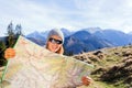 Woman Hiker Reading Map In Mountains
