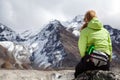 Woman hiker relaxing on rocks in Himalaya Mountains, Nepal Royalty Free Stock Photo