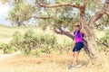 Woman hiker resting in tree grove, Crete Island, Greece