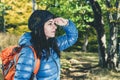 Female hiker searching forest