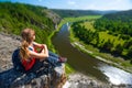 Woman hiker sits on the rock Royalty Free Stock Photo