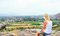 Woman hiker sits on top of a mountain and relaxes while eating an apple. Royalty Free Stock Photo