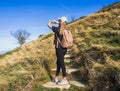 Woman hiker standing with her arms up on her way to the top. Conceptual design. Royalty Free Stock Photo