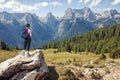 Woman hiker standing on stone rock and looking at mountains Royalty Free Stock Photo