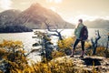 Woman hiker stands on the coast of the lake