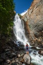 Woman hiker stands on the rock Royalty Free Stock Photo