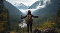 Female traveler climb high rock. Girl walk with nordic pole Mountains background Royalty Free Stock Photo