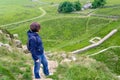 Woman Hiker on a Steep Hillside Path