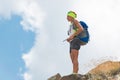 Woman hiker stops in the mountains