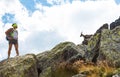 Woman hiker stops to watch an ibex