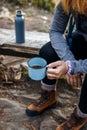 Woman hiker taking a break with hot drink during mountain trekking Royalty Free Stock Photo