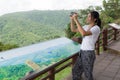 Woman hiker taking photo with camera at mountain Royalty Free Stock Photo