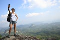 Woman hiker taking photo with cellphone