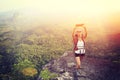 Woman hiker taking photo with smart phone at mountain peak Royalty Free Stock Photo