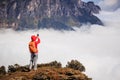 Woman hiker taking photo with smart phone on mountain peak Royalty Free Stock Photo